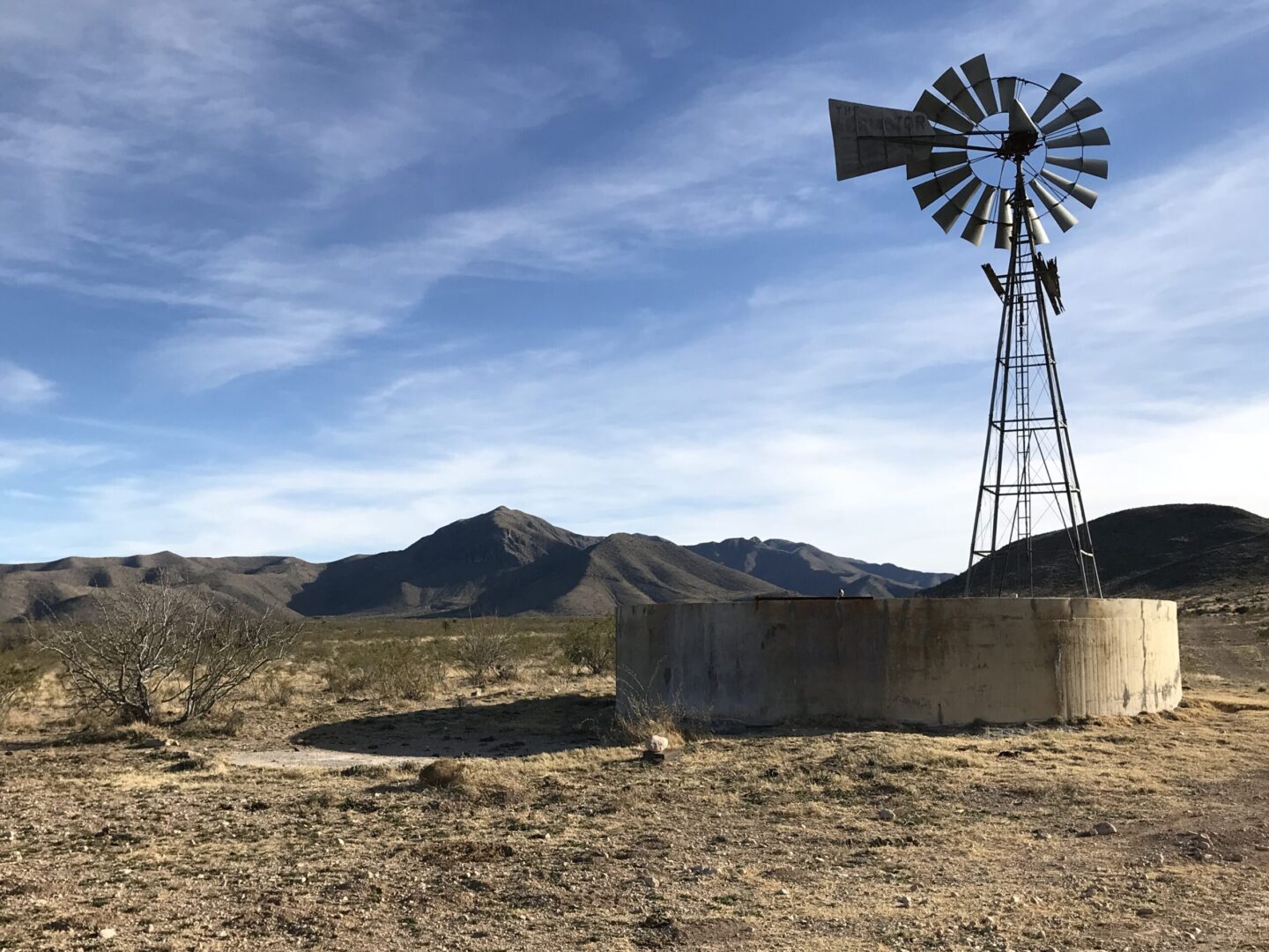 A windmill is standing in the middle of nowhere.